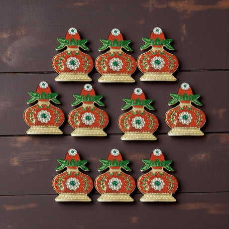 Red and gold ceramic Christmas ornaments with floral patterns and glossy finish for Diwali and Pooja decor