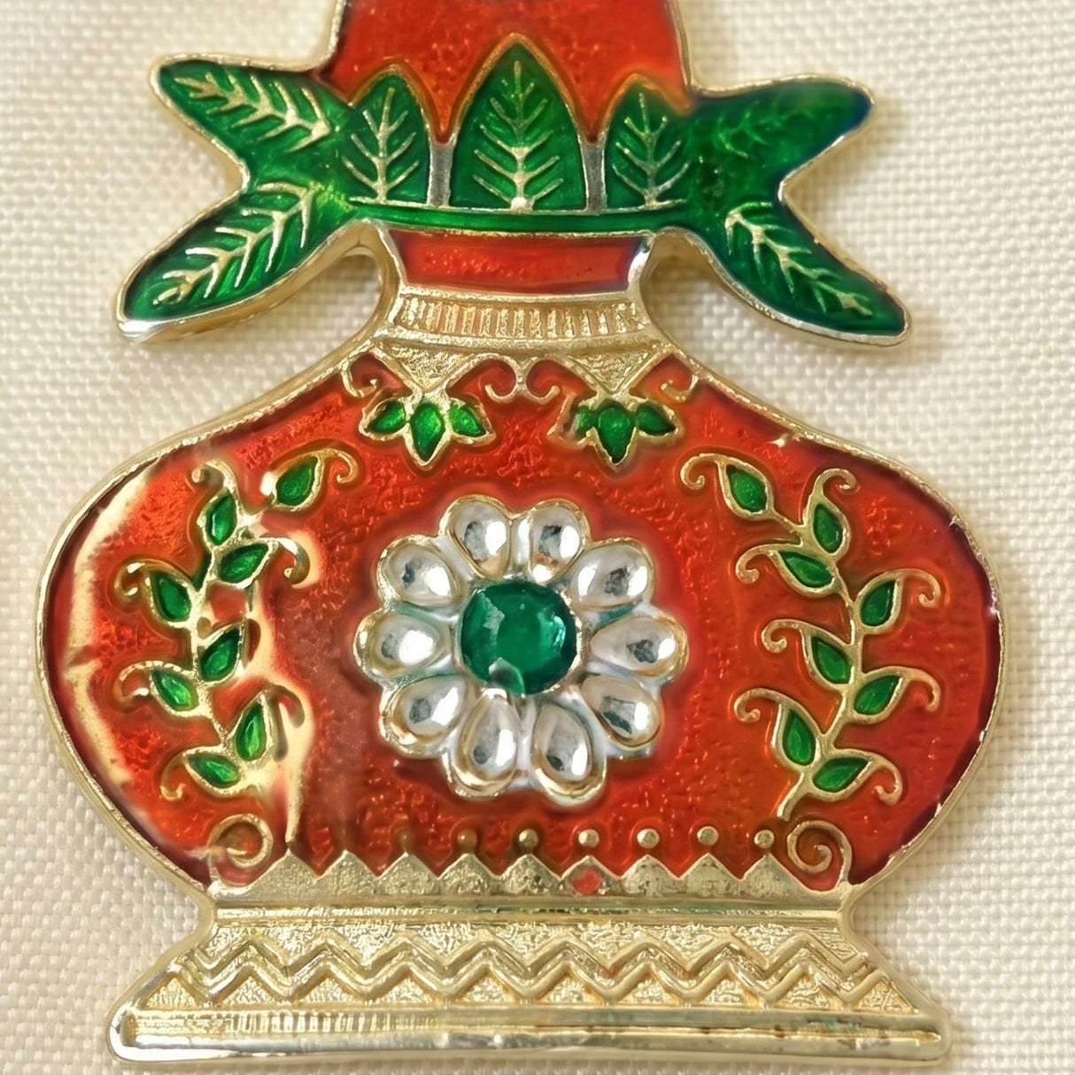 Red and gold enamel kalash haldi kumkum holder pin with green leaves and emerald gem for indian festival pooja rituals