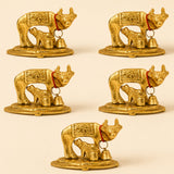 Golden metallic Kamadhenu cow and calf figurines with intricate engravings and red cords with bells brass finish statue