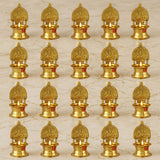 Golden brass Kamakshi Deepam oil lamps with intricate deity carvings and small lit candles for Diwali pooja