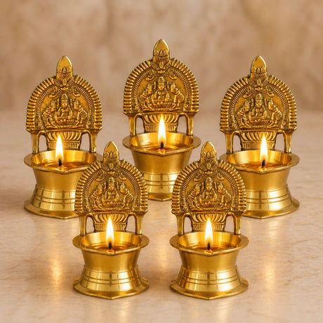 Kamakshi deepam brass diya featuring golden brass oil lamps with intricate goddess lakshmi carvings for diwali pooja and ceremonies