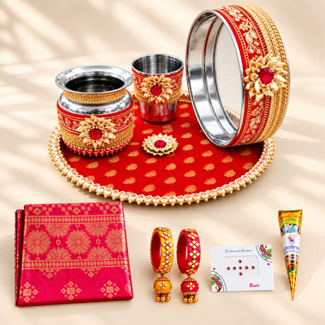 Red and gold ornate karwa chauth pooja thali set with intricate floral designs for traditional festive gifting
