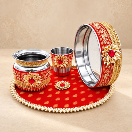 Red and gold ornate karwa chauth pooja thali set with intricate floral designs and red gemstone accents for women
