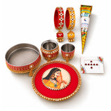 Red and gold ornate circular karwa chauth pooja thali with painted portrait of indian woman in traditional attire