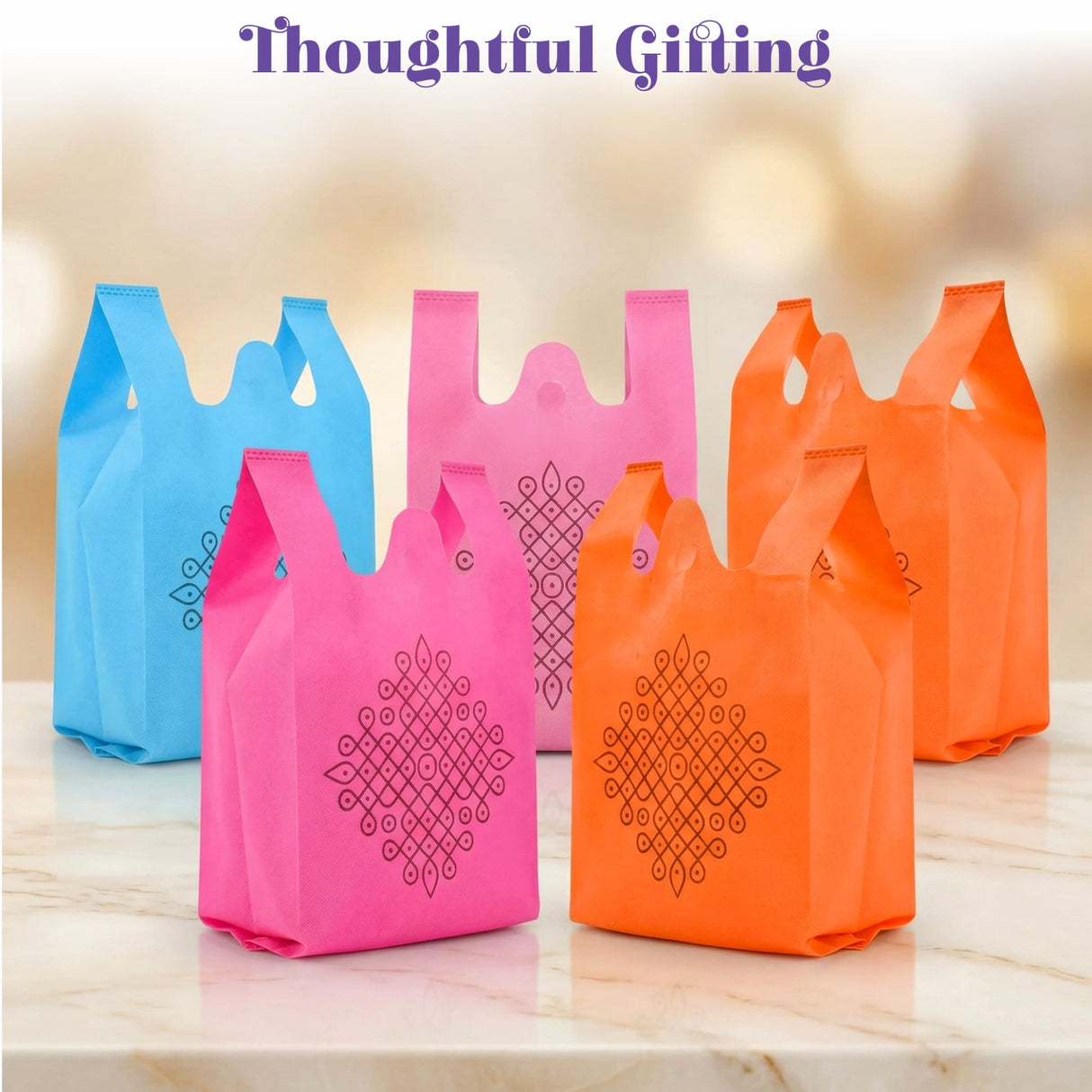 Brightly colored blue pink and orange kolam print non woven reusable bags with black geometric patterns for Indian weddings