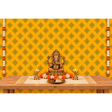 Golden brass statue of lord ganesha seated in a meditative pose with four arms and intricate detailing for pooja decor