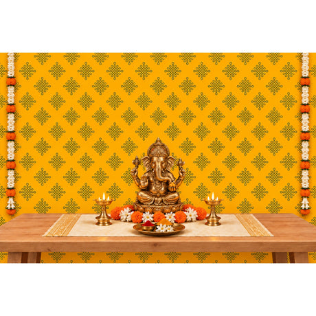 Golden brass statue of lord ganesha seated in a meditative pose with four arms and intricate detailing for pooja decor