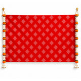Vibrant red kolam rangoli print fabric backdrop with white geometric pattern and marigold jasmine garlands for diwali decor