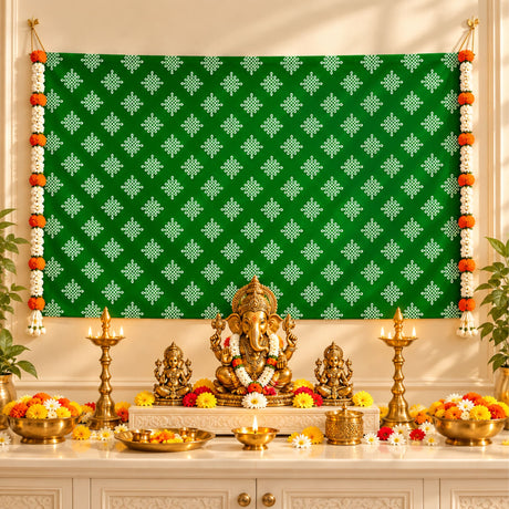 Golden ganesha idol adorned with floral garland seated on ornate pedestal with kolam rangoli print backdrop and artificial garlands