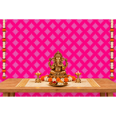 Golden ganesha statue with intricate detailing and traditional seated pose featured with kolam rangoli backdrop and floral garlands