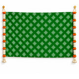 Green kolam rangoli print fabric banner with white geometric patterns and artificial marigold and jasmine garlands