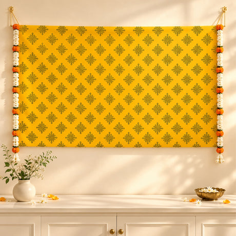 Bright yellow kolam rangoli print backdrop with dark green geometric pattern and artificial marigold jasmine garlands