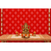 Golden ganesha statue with intricate detailing seated on pedestal with marigold and white flowers in kolam rangoli backdrop set