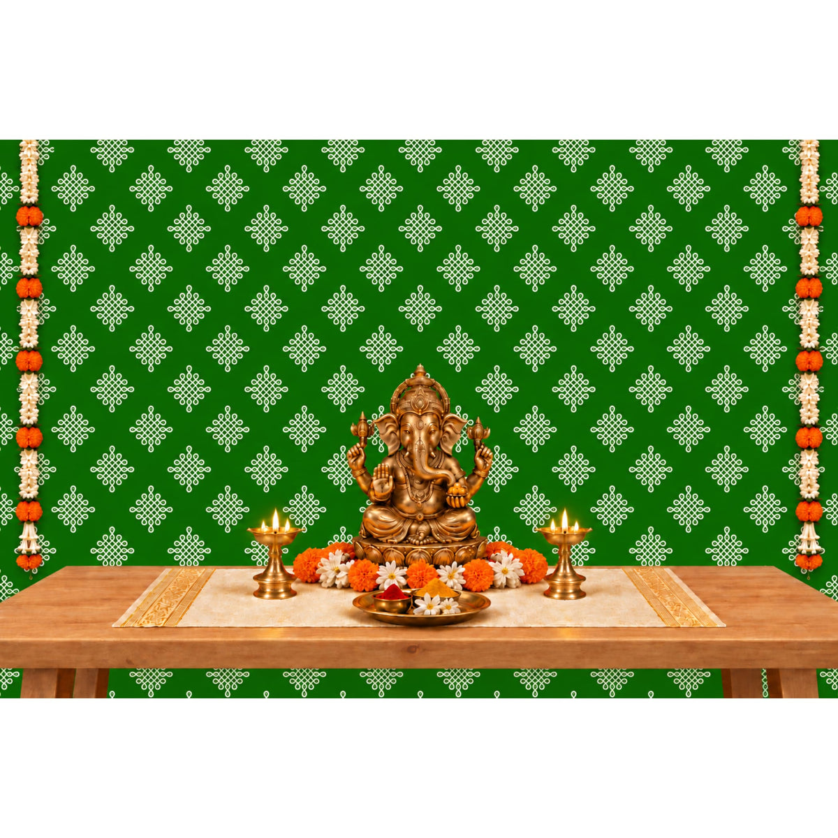 Golden ganesha statue with intricate detailing seated in a meditative pose on kolam rangoli backdrop with marigold garlands