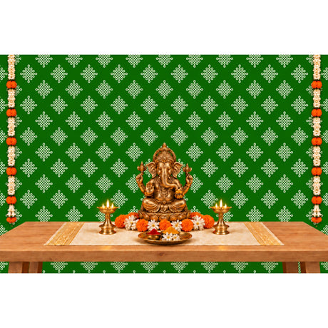 Golden ganesha statue with intricate detailing seated in a meditative pose on kolam rangoli backdrop with marigold garlands