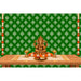 Golden ganesha statue with intricate detailing seated in a meditative pose on kolam rangoli backdrop with marigold garlands