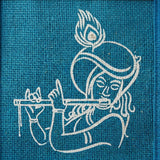 White embroidered figure playing flute on teal fabric jute bag with krishna print reusable tote for wedding gifts