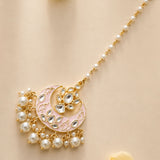 A gold-toned crescent-shaped kundan chand tikka with pink enamel clear stones and dangling white pearls for Indian weddings