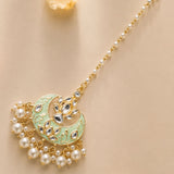 Kundan chand maang tikka with gold plating in mint green and gold featuring sparkling stones and dangling pearls for weddings