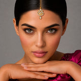 Gold-plated kundan work maang tikka with intricate floral detailing and sparkling stones for wedding jewelry