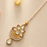 Gold-plated kundan work maang tikka with intricate floral design and clear stones for traditional Indian and Punjabi weddings