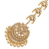 Gold-toned chandbali maang tikka with intricate filigree, faceted crystals, and round pearls for indian bridal use