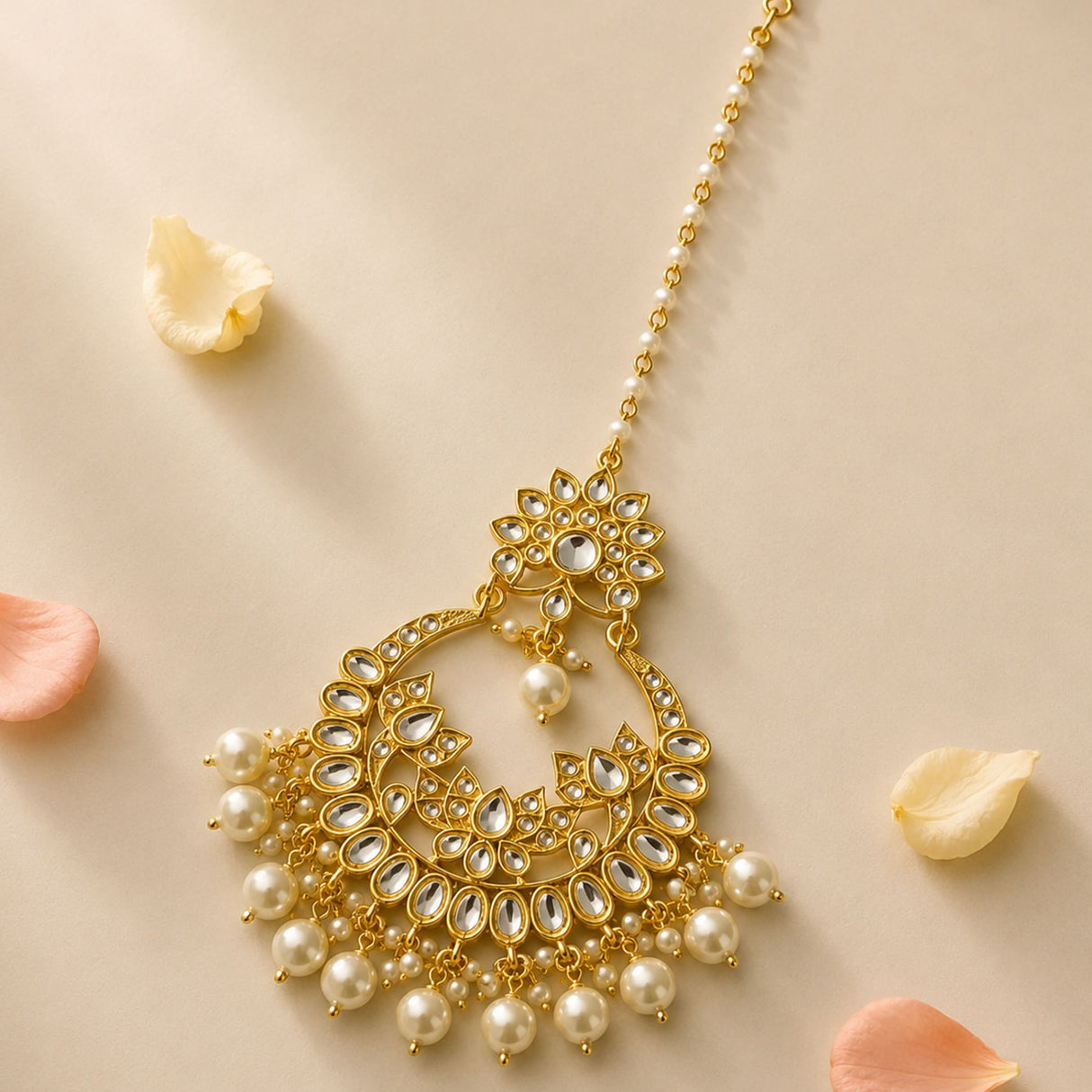 Gold-plated kundan choker-style maang tikka with intricate filigree, faceted stones, and dangling pearls for weddings
