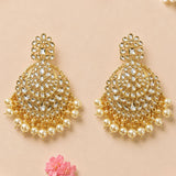 Gold tone oversized Indian kundan chandelier earrings with intricate metalwork and faux pearl dangles for ethnic wear