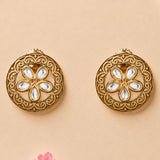 Indian kundan stud earrings in golden tone featuring intricate filigree and clear teardrop stones in floral design