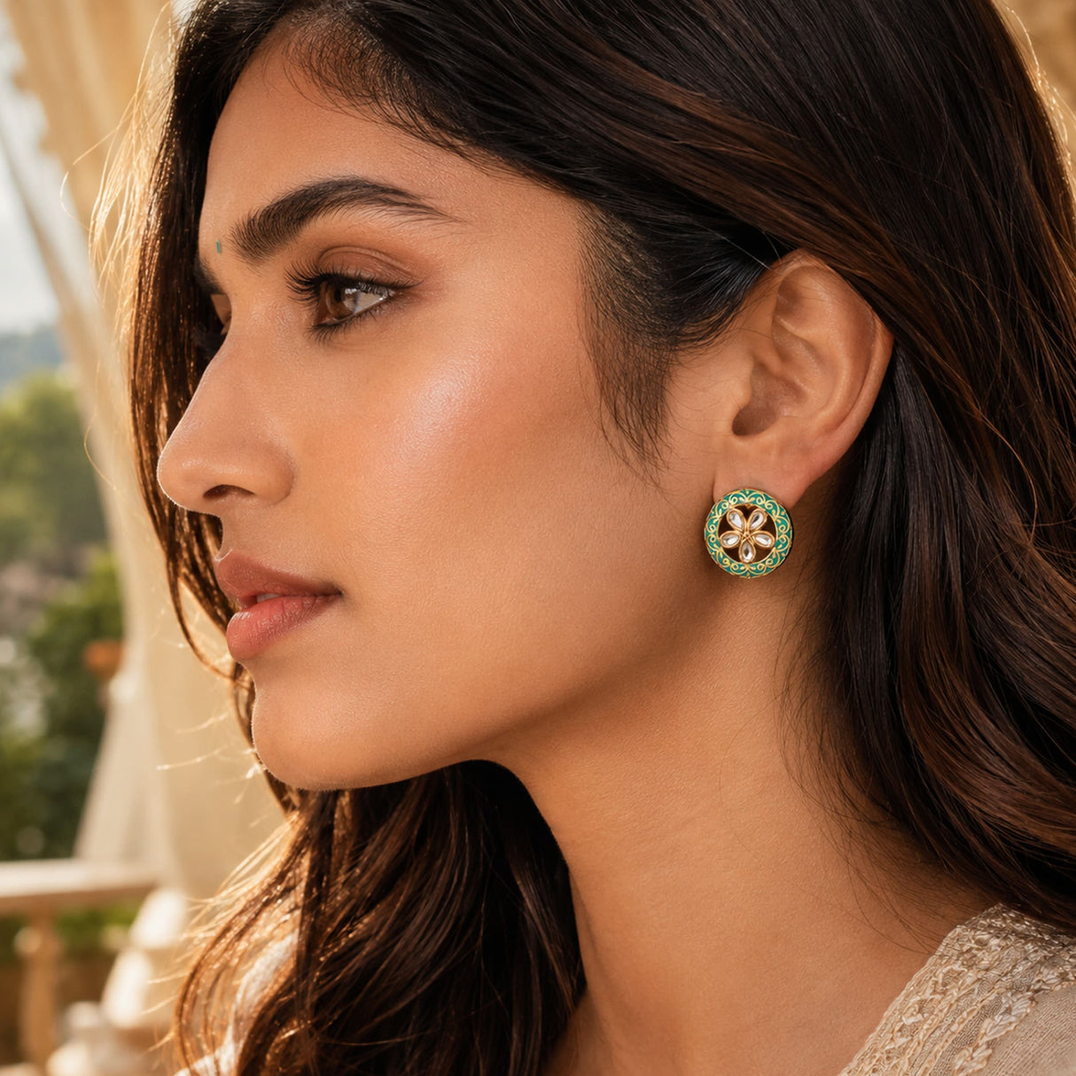 Green and gold floral kundan stud earring with intricate detailing and pearl tassel in a golden tone for bridal wear