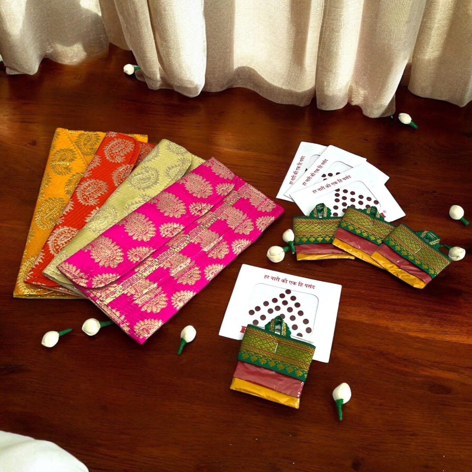 Colorful brocade envelopes with traditional game pieces for Navratri Kanya Pujan celebrations
