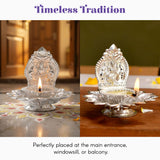Silver-plated lakshmi diya with intricate floral and deity carvings, lotus-shaped base, ornate lid for diwali puja decor