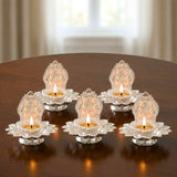 Lakshmi silver plated diya oil lamps with intricate lotus engraving and burning wicks for Diwali puja decor