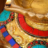 Large brass indian oil lamp with engraved patterns red turquoise mosaic and flame for diwali pooja decoration