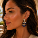 Elegant gold tone Indian floral kundan chandelier earrings with deep blue oval beads and clear crystals for ethnic wear