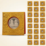 Golden textured coin display case holding a silver plated laxmi ganesh commemorative coin with velvet gift packing for pooja