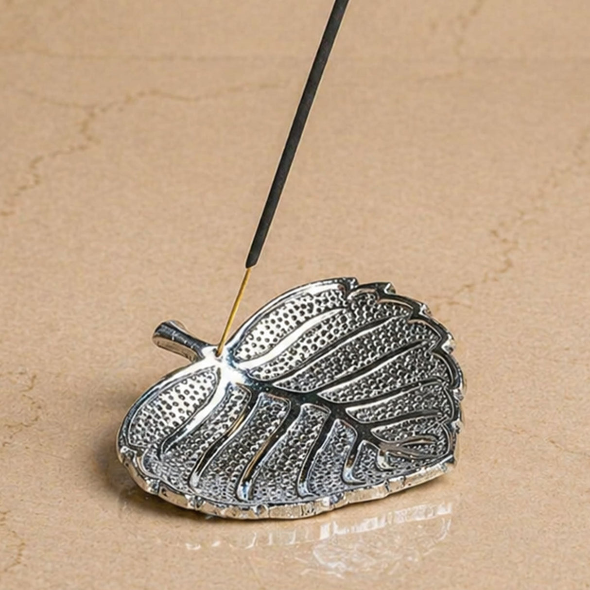 Silver leaf-shaped incense stick and cone holder with textured surface and detailed vein patterns for pooja decor