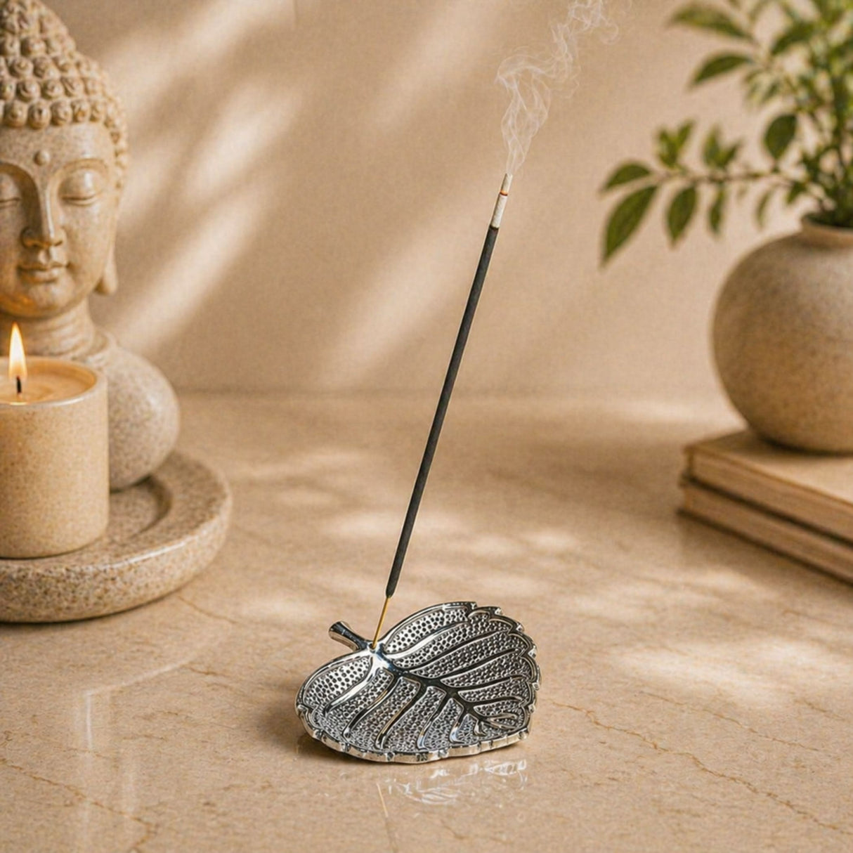 Silver leaf-shaped incense holder with intricate etched detailing for pooja and living room decor