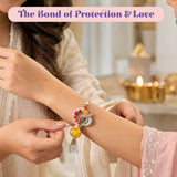 Elegant designer leaf lumba rakhi bracelet set with red and white thread, silver metalwork, gemstones, and golden pendant for Raksha Bandhan gift