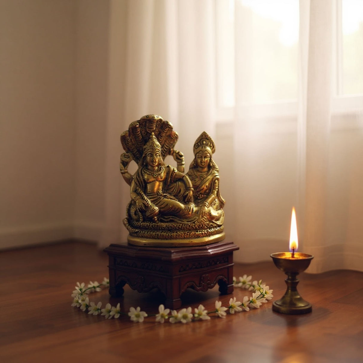 Gold brass statue of Lord Vishnu and Lakshmi Ji on wooden base with floral decorations