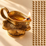 Golden brass finish lotus diya oil lamp with intricate floral base design and lit flame for home pooja decor