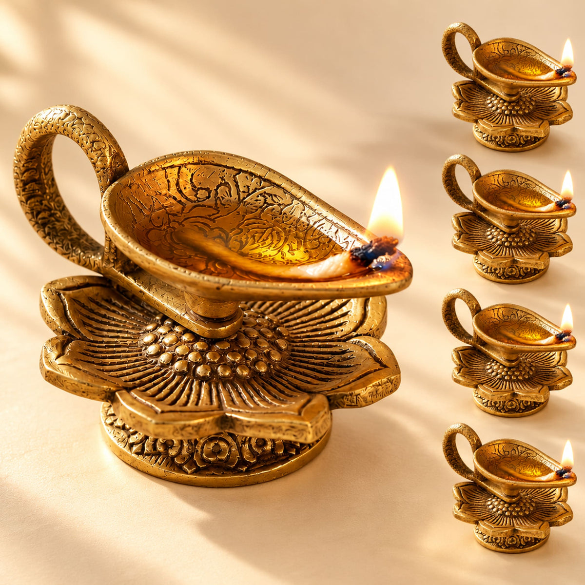 Golden brass finish lotus diya with intricate floral engravings and lit candle lightweight aluminum oil lamp for pooja