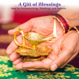 Golden lotus brass finish diya oil lamp with intricate floral engravings and lit wick held in hands for pooja decor