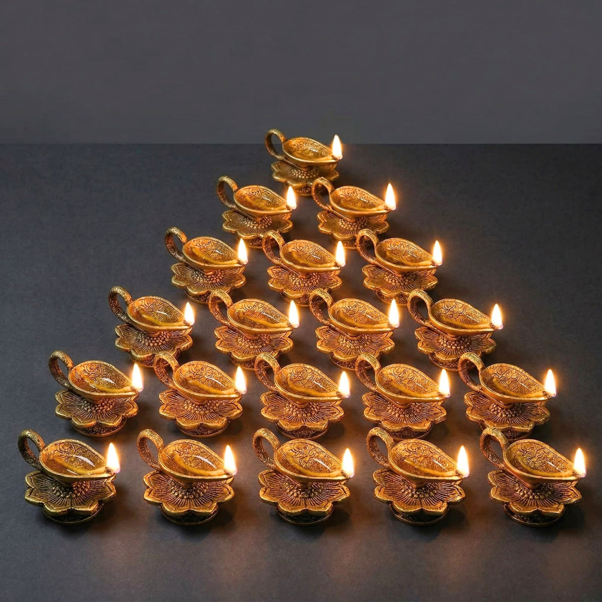 Golden brass lotus finish Diya oil lamps with intricate floral engravings and lit wicks for Diwali pooja decor