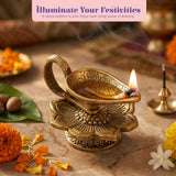Golden brass oil lamp with intricate floral engravings and lit flame for home pooja Diwali decor and religious use