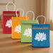 Four colorful jute tote bags with white lotus design and gold trim for bridesmaid gift travel shopping indian wedding favor