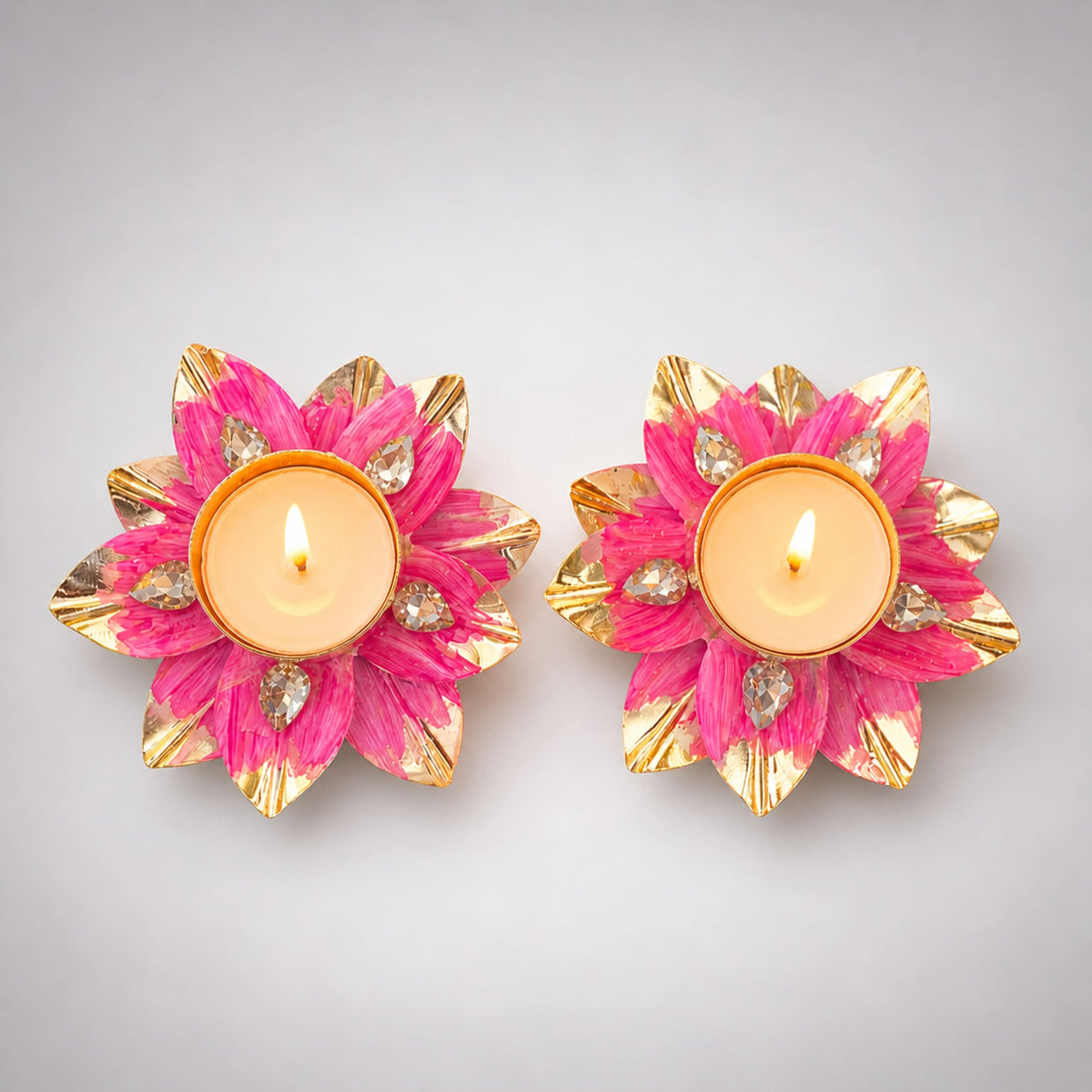 Vibrant pink and gold lotus tealight candle holders with sparkling crystal accents for Diwali pooja and home decor