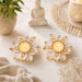 Two white and gold lotus-shaped tealight holders with faceted gemstone accents for decorative diya and festive use