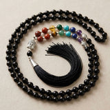 Black beaded LOVENSPIRE 108 mala necklace with silver buddha head pendant colorful chakra gemstones and black tassel