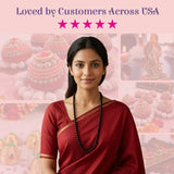 A woman wearing a red sari with gold trim displays lovenspire 108 mala beads black beaded meditation necklace